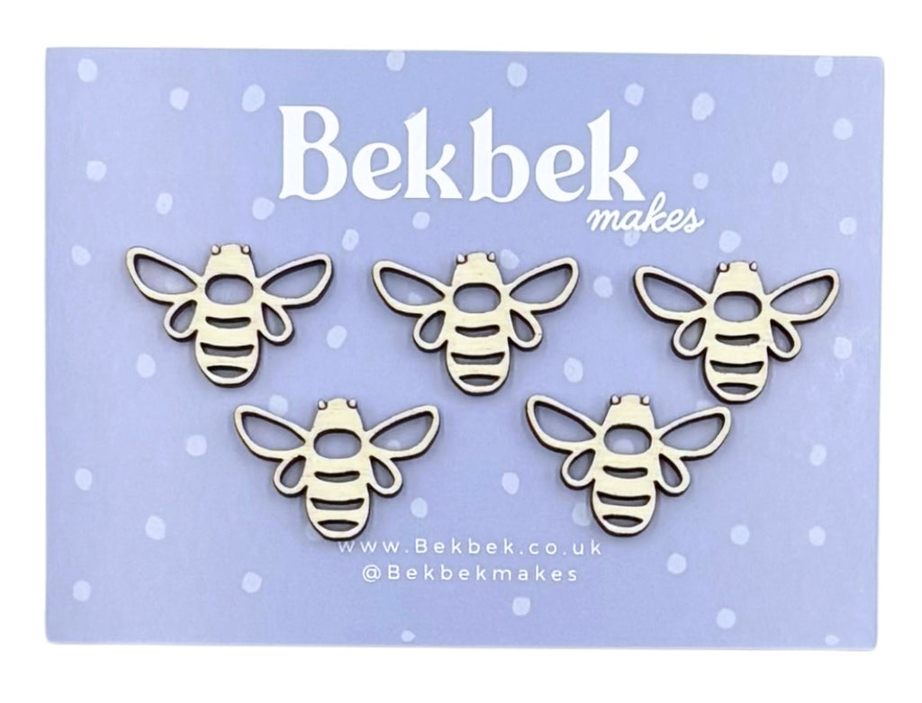 Five unfinished wooden bee craft pieces displayed on a light purple card with the brand name 'Bekbek makes' printed at the top.