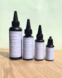 Four bottles of Bekbek Makes UV Resin on a wooden surface with a light green background